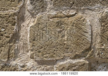 detail of wall built with stone blocks carved by hand, subsequently restored, Romanesque centuries XI, XII