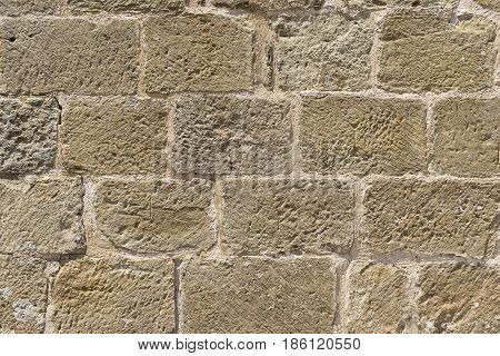 Wall built with blocks of hand carved stone, subsequently restored, Romanesque XI century, XII