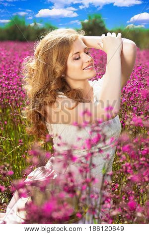 Enjoy Every Moment. Portrait Of Beautiful Young Redhead Girl In White Dress Posing In Flower Country