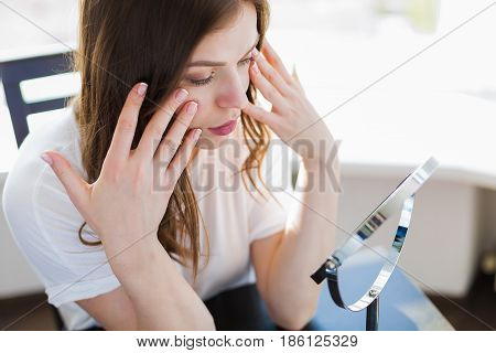 Woman Sitting By The Mirror