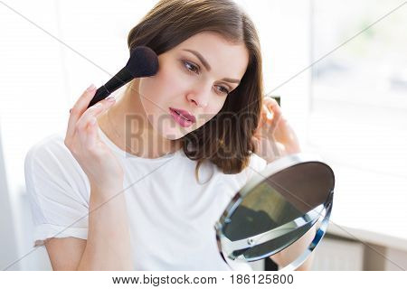 Woman Sitting By The Mirror