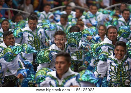 ORURO, BOLIVIA - FEBRUARY 26, 2017: Caporales dancers in ornate costumes performing as they parade through the mining city of Oruro on the Altiplano of Bolivia during the annual carnival.