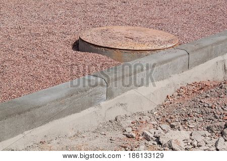 Concrete curb on new building site. Roadwork