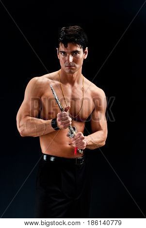 The hot sexy warrior is about to pull out his weapon.