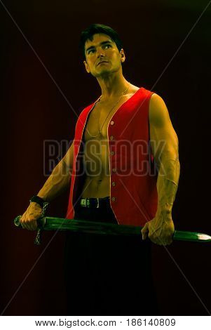 The sexy Viking is holding on to his sword tight.