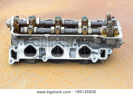 old engine Cylinder head on rusty steel