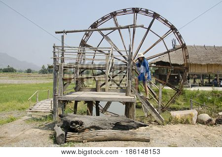 Thai Women People Travel And Posing With Big Wooden Turbine Baler Water Wheel