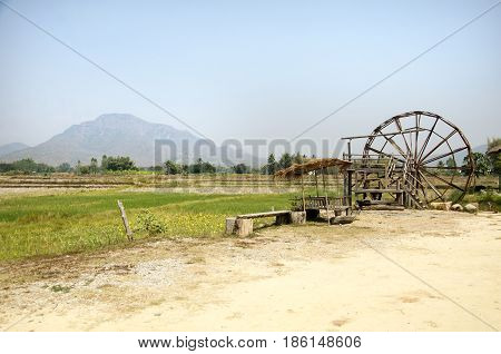 Thai Dam Cultural Village And Big Wooden Turbine Baler Water Wheel Or Wood Noria Water With Landscap