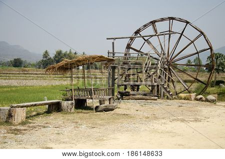 Thai Dam Cultural Village And Big Wooden Turbine Baler Water Wheel Or Wood Noria Water With Landscap