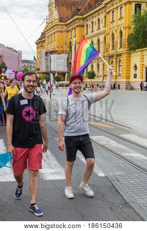 ZAGREB, CROATIA - JUNE 11, 2016: 15th Zagreb pride. LGBTIQ activist holding flag.