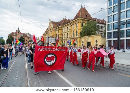 ZAGREB, CROATIA - JUNE 11, 2016: 15th Zagreb pride. LGBTIQ activists holding pride banner.