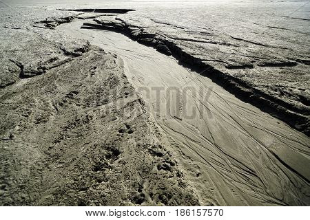 Dried creek with a pattern on the sand. Siberia, spring, the Ob Sea.