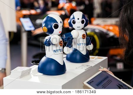 Hannover, Germany - March, 2017: Exhibition stand of NTT Group comapany with two small robots on fair Cebit 2017 in Hannover Messe, Germany