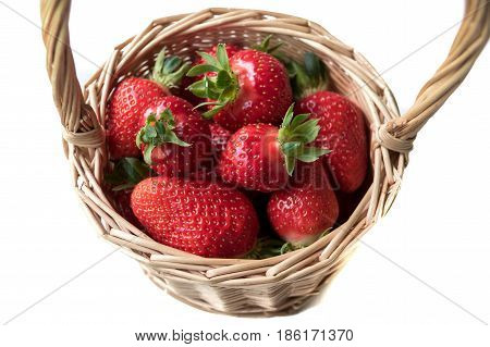 Red juicy ripe strawberry in a basket on a white background