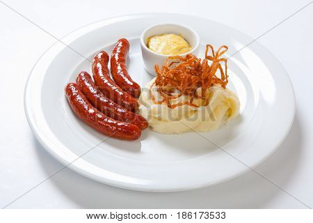 Mashed Potato And Roasted Sausage Or Bratwurst On White Plate
