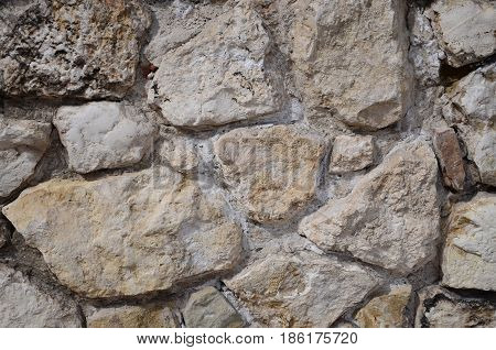 Old, historic wall of white untreated stone