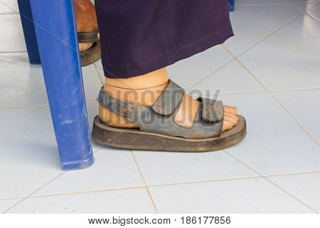 closeup wooden prostheses of a male who sitting on blue chair