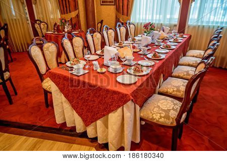 Big table at retaurant served for upcoming banquet