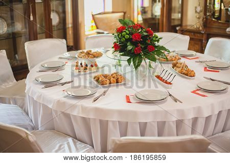 Wedding decor. restaurant interior. Festive white decor, table layout concept. expectation of guests.
