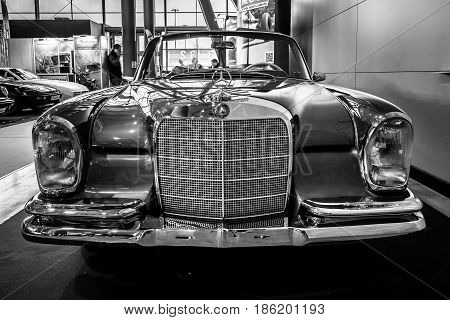 STUTTGART GERMANY - MARCH 02 2017: Full-size luxury car Mercedes-Benz 300 SE Cabriolet (W112) 1967. Black and white. Europe's greatest classic car exhibition 