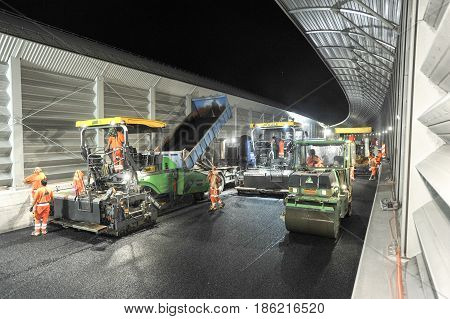 Workers And Vehicles During The Asphalting Of The Highway