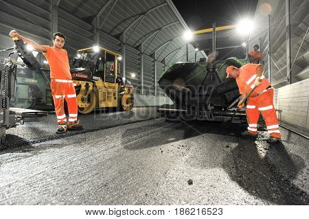 Workers And Vehicles During The Asphalting Of The Highway