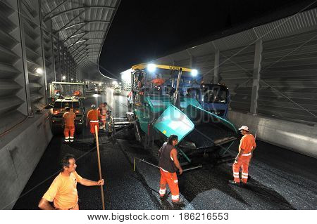 Workers And Vehicles During The Asphalting Of The Highway