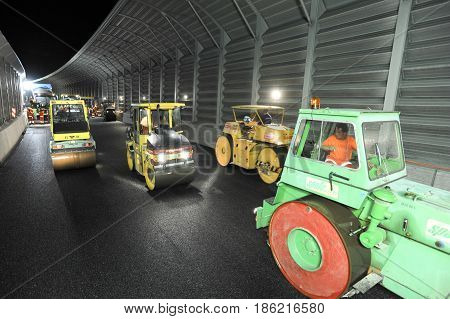 Workers And Vehicles During The Asphalting Of The Highway