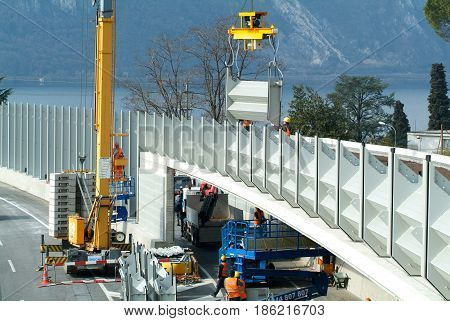 Workers During The Installation Of Noise Barriers On The Highway