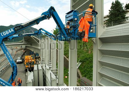 Workers During The Installation Of Noise Barriers On The Highway