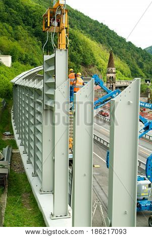 Workers During The Installation Of Noise Barriers On The Highway