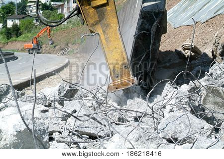 Hydraulic Digger Breaking Up A Wall