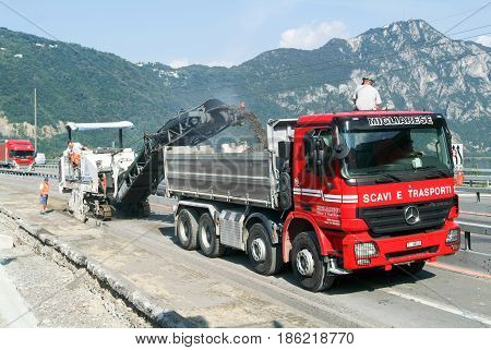 Workers And Vehicles During The Road Milling Of The Highway