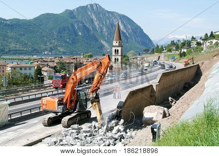Hydraulic Digger Breaking Up A Wall