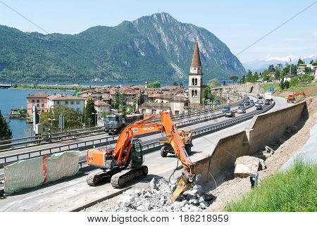 Hydraulic Digger Breaking Up A Wall