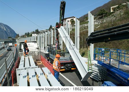Workers During The Installation Of Noise Barriers On The Highway