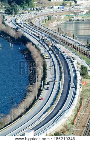 Workers And Vehicles During The Asphalting Of The Highway