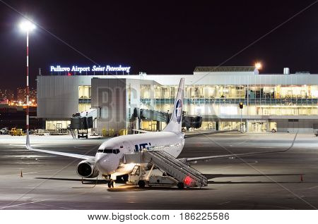 Night View Of The Airport And The Plane Of The Airline Utair. Russia, Saint-petersburg April 2017.