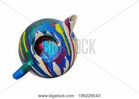 Old multicolor painted teapot isolated on the white background close-up with copy space