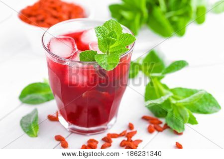Healthy detox drink with goji berries infused in water with ice cold refreshing beverage