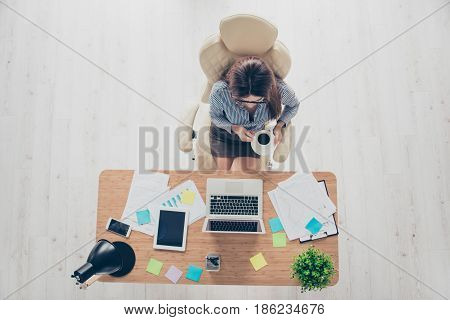 Top Up Of A Lady Lawyer Having A Coffee Break At Her Work Place And Looking At The Screen Of Laptop
