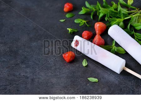 Eskimo - ice cream with strawberries and birch juice on a black concrete background