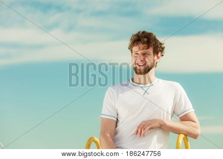 Happy fashion young man guy relaxing enjoying summer sunny day outdoor. Vacation holiday.
