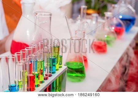 Laboratory expreriment with test-tubes with colored chemical reagents, retorts and flasks
