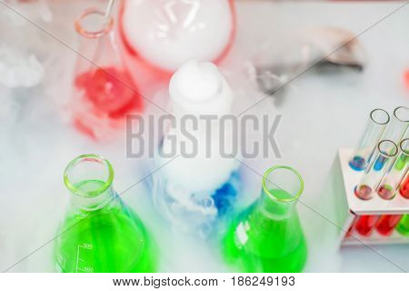 Laboratory expreriment with test-tubes with colored chemical reagents, retorts and flasks