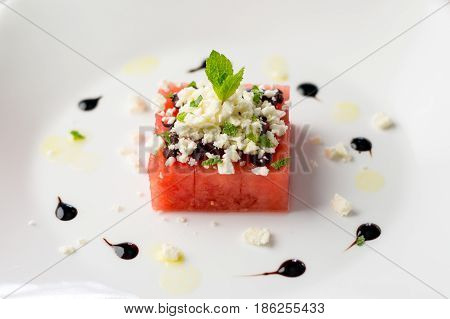 Watermelon salad on white. This watermelon cubes salad is made with greek feta cheese crumbs olive slices mint olive oil and balsamic vinegar. So refreshing the perfect food for the summer!