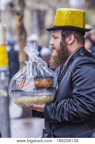 JERUSALEM - MARCH 13 : Ultra Orthodox man holding Mishloach Manot during Purim in Mea Shearim Jerusalem on March 13 2017 Mishloach Manot is traditional food gifts given during Purim