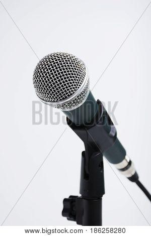 closeup a microphone on stand isolated on white background