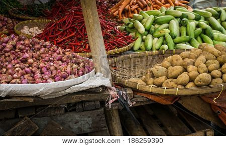red onion potato cucumber and red chilli with bamboo wooden basket on traditional market in bogor indonesia java
