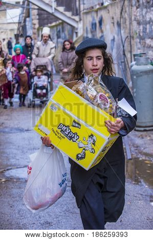 JERUSALEM - MARCH 13 : Ultra Orthodox man holding Mishloach Manot during Purim in Mea Shearim Jerusalem on March 13 2017 Mishloach Manot is traditional food gifts given during Purim